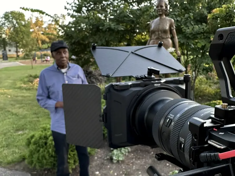The Field Production filming a documentary interview on location in a Detroit park